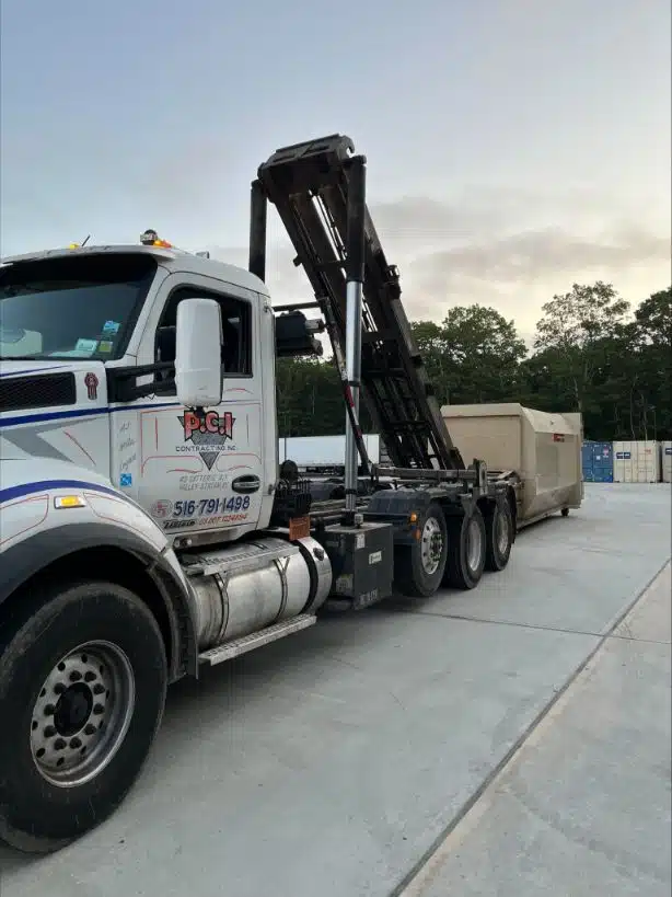 Crushed Stone Supplier & Delivery Manhattan: Reliable crushed stone supplier & delivery service in Manhattan. Large truck with crane for efficient transportation.. Photo taken on January 2024.