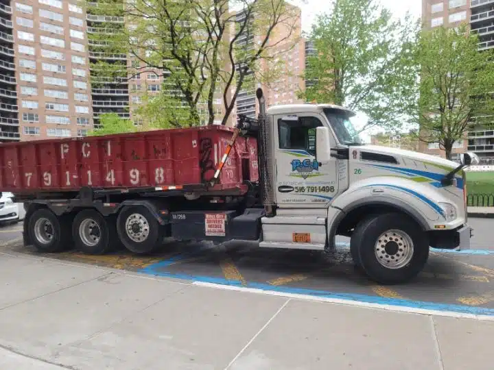 Construction Trash Dumpster Rental: Choose our construction trash dumpster service! PCI truck outside the building with an ongoing project. Photo Taken March 2023.