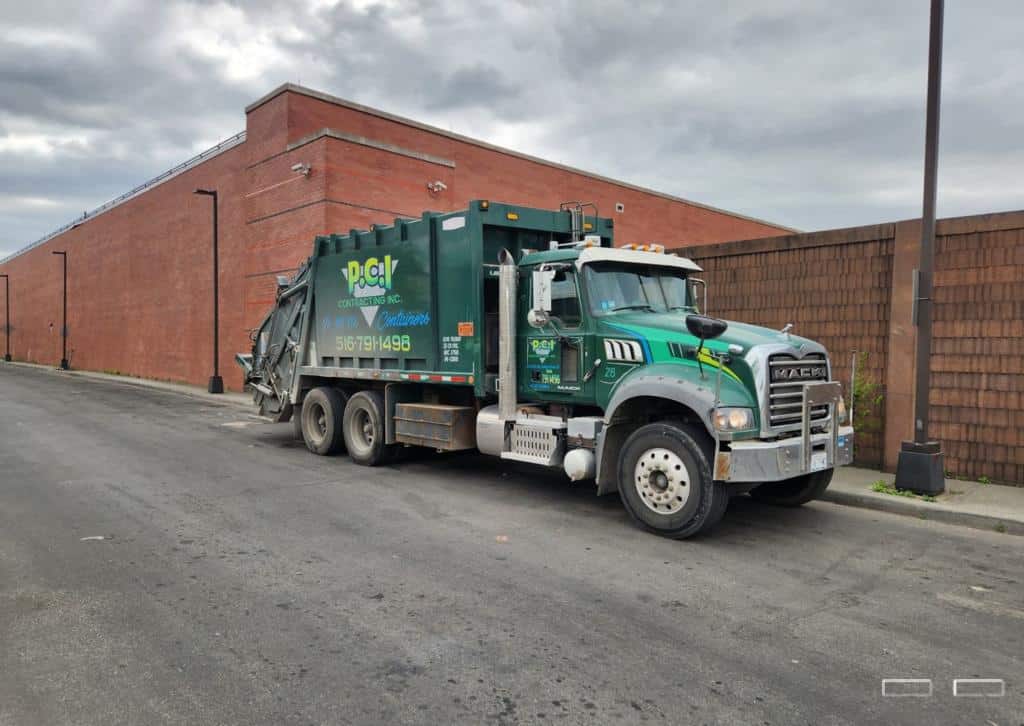 How to Rent a Dumpster in NYC in New York City 3 ### Key Elements - **Main Subject**: Garbage truck - **Color Scheme**: Green and black -
